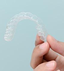 Patient holding clear aligner