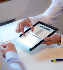 Patient reviewing dental insurance forms on tablet