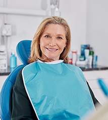 Senior woman sitting in dental chair smiling