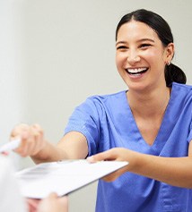 Patient in Columbus filling out paperwork for teeth whitening