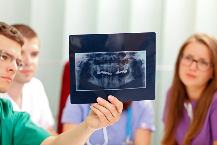 Dental team looking at an x-ray