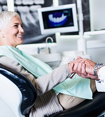 A woman shaking hands with her dentist