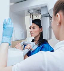 A woman at a cone beam scanner