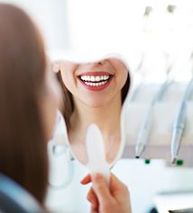 Patient smiling at reflection in mirror