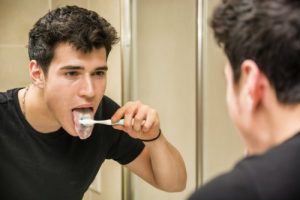 man brushing his tongue