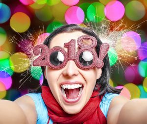 Woman with beautiful smile and 2018 New Year's glasses