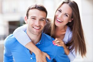 Man and woman smiling together.