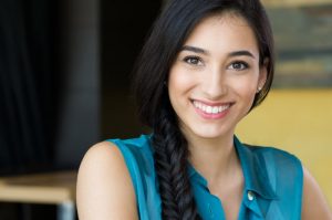 Professionally dressed woman smiling.