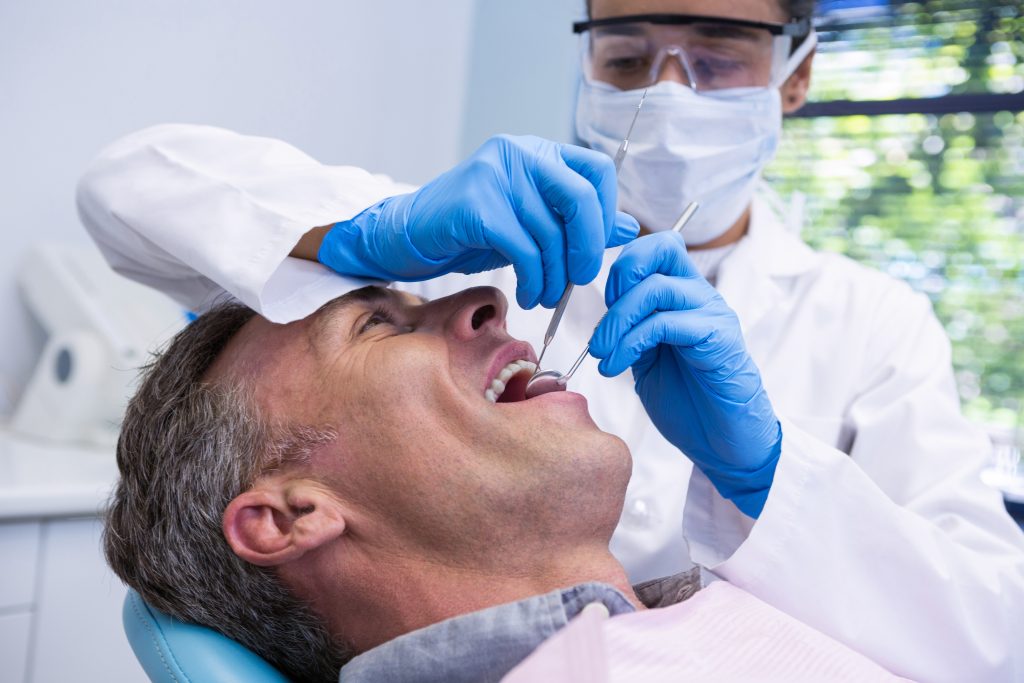 man mouth open for root canal