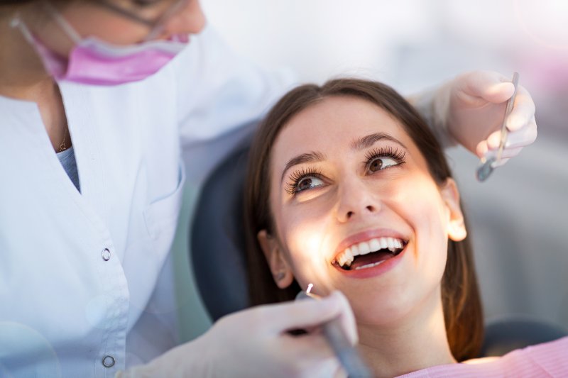 Patient smiling at dentist during dental exam