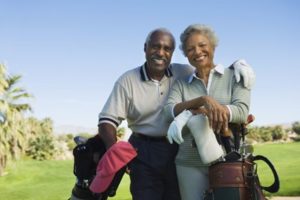 Senior couple smiling on a golf course