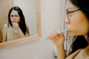 Woman brushing her teeth at dentist in Upper Arlington