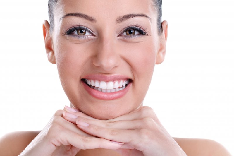 a woman showing off her smile after receiving cosmetic dentistry in Upper Arlington