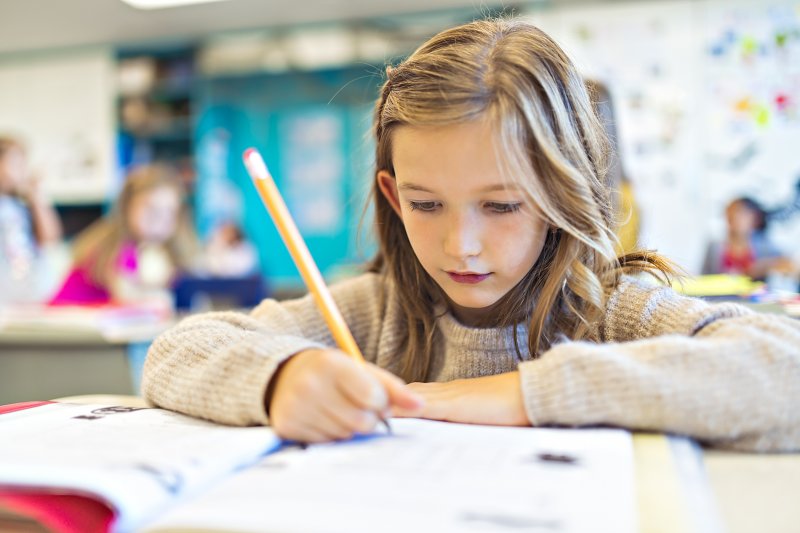 young girl studying in classroom