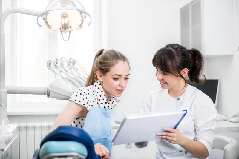 Dentist teaching patient how to prepare for Invisalign