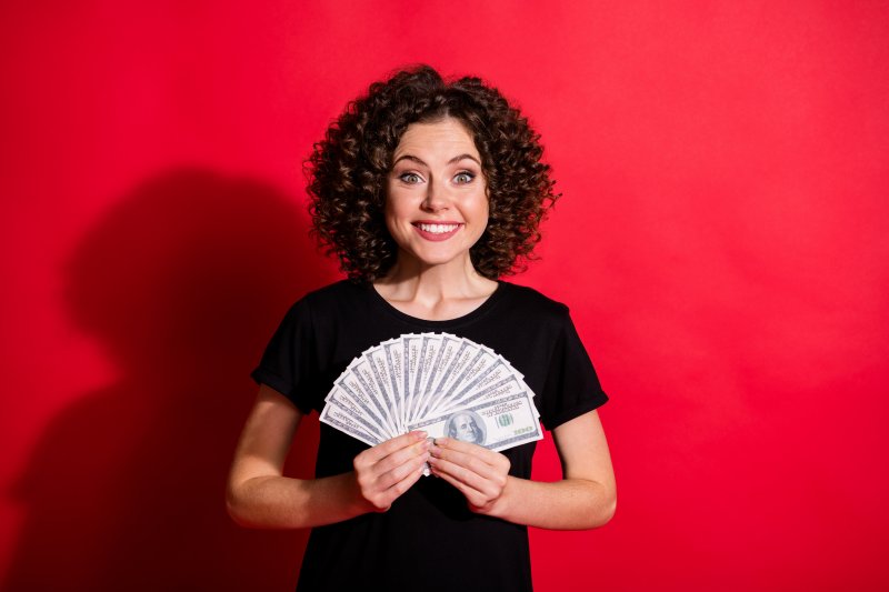 woman smiling while holding money in Upper Arlington